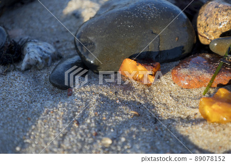 Amber on fine sand, beautiful piece of amber from the sand. Amber on fine sand, beautiful piece of amber from the sand. 89078152