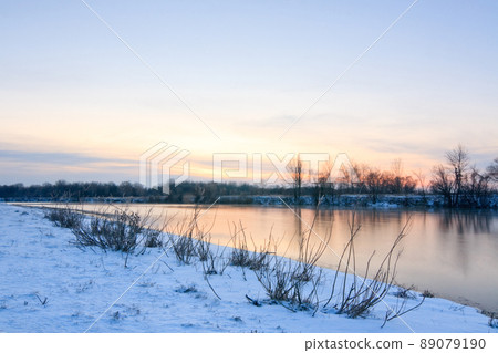 Beautiful winter landscape with frozen lake and sunset sky. Composition of nature. 89079190