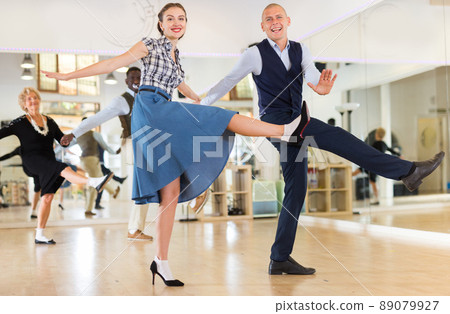 Man and woman performing jazz dance in dancing room 89079927