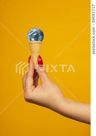 Woman hand holding small crispy ice cream cone Woman hand holding small crispy ice cream cone 89081717