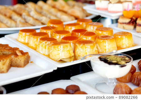 Caramel vanilla flan. Dessert table in a Turkish hotel. Various cakes and sweets on buffet. Caramel vanilla flan. Dessert table in a Turkish hotel. Various cakes and sweets on buffet. 89082266