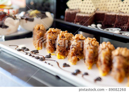 Caramel apple pie with walnuts. Dessert table in a Turkish hotel. Various cakes and sweets on buffet. Caramel apple pie with walnuts. Dessert table in a Turkish hotel. Various cakes and sweets on buffet. 89082268