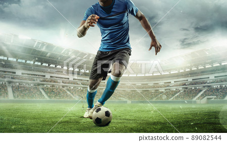 Cropped image of running soccer, football player at stadium during football match. Concept of sport, competition, goals 89082544