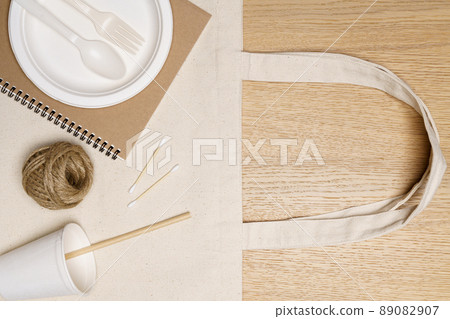 Eco friendly concept, Eco bag with notebook food container and jute rope on wooden background Eco friendly concept, Eco bag with notebook food container and jute rope on wooden background 89082907