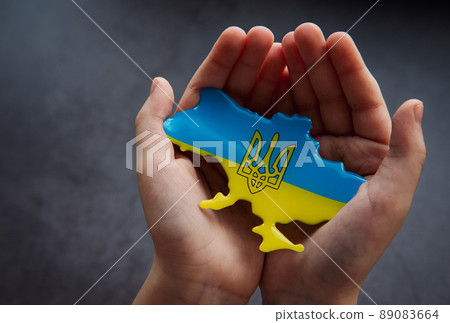 Hands holding the shape of Ukraine border with color flag Hands holding the shape of Ukraine border with color flag 89083664