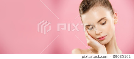 Beauty skin Concept - Beautiful Young Caucasian Woman with Clean Fresh Skin look away with pink studio background. Girl beauty face care. Facial treatment. Cosmetology , beauty and spa. 89085161
