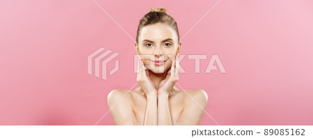 Beauty Concept - Beautiful Woman with Clean Fresh Skin close up on pink studio. Skin care face. Cosmetology. 89085162