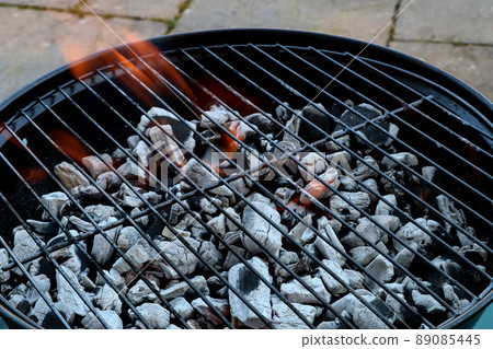 Flaming Barbecue Charcoal on a Garden Patio Flaming Barbecue Charcoal on a Garden Patio 89085445