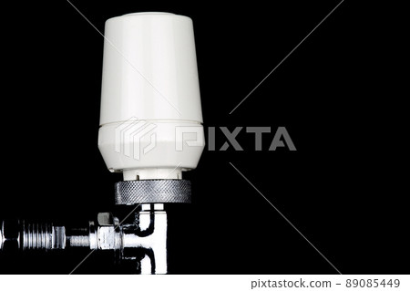 Radiator Thermostat Valve on a Black Background 89085449