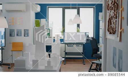 Nobody in office with blueprints plans to design building model for architecture project. Empty space with maquette and construction structure used for urban property development. Nobody in office with blueprints plans to design building model for architecture project. Empty space with maquette and construction structure used for urban property development. 89085544