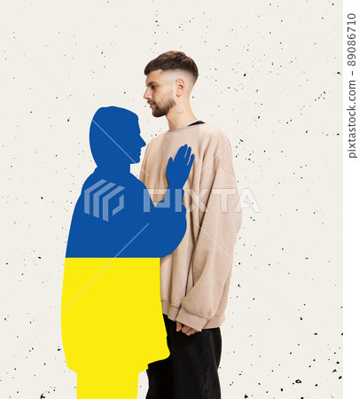 Contemporary art collage. Silhuoette of young woman painted in ukrainian flag colors hugging man painted in ukrainian flag colors. Feeling of loss. 89086710