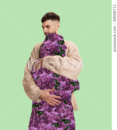 Contemporary art collage. Man lovely hugging silhouette of woman filled with flowers isolated over mint background 89086711