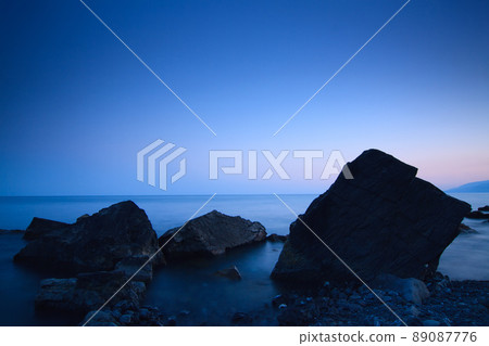 Sea rocks at sunset. Breathtaking sunset view on the Black Sea coast, Crimea. Sea rocks at sunset. Breathtaking sunset view on the Black Sea coast, Crimea. 89087776