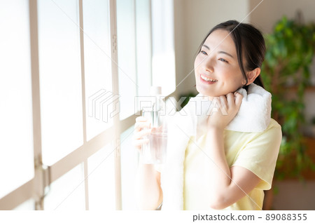 Women supplementing with a window by the window Women supplementing with a window by the window 89088355