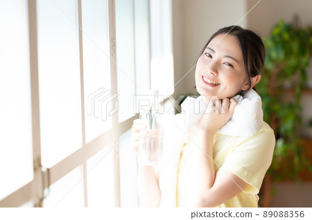 Women supplementing with a window by the window Women supplementing with a window by the window 89088356