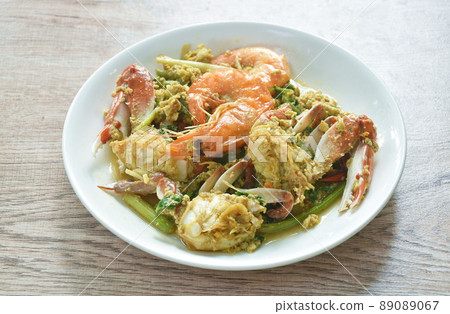 stir fried swimmer crab and shrimp in yellow curry with egg on plate stir fried swimmer crab and shrimp in yellow curry with egg on plate 89089067