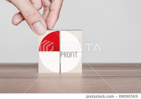Hand put a tax icon on wooden cubes block on wood table. Concept of tax return obligation and taxation in next year. 89090569