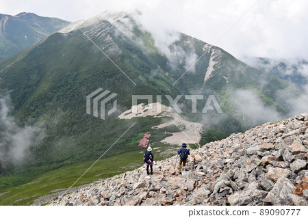 Climbers on the mountain trail towards the Jonen Pass and the Jonen Hut Climbers on the mountain trail towards the Jonen Pass and the Jonen Hut 89090777