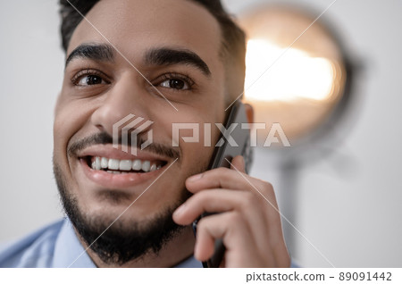 A smiling young businessman with a phone A smiling young businessman with a phone 89091442
