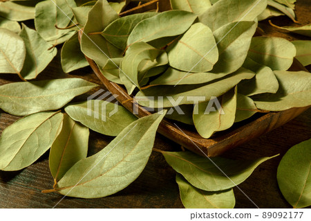 Bay leaves in a wooden bowl on a rustic background Bay leaves in a wooden bowl on a rustic background 89092177