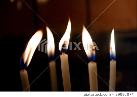 Fire of candles on christmas background.  Candles burning at night. 89093074