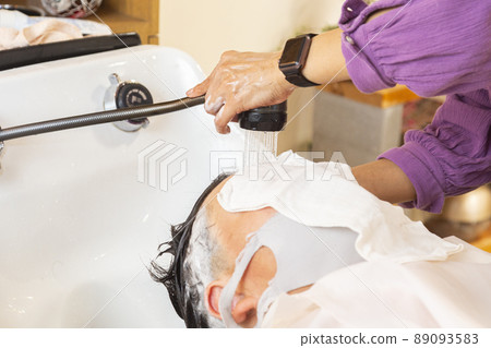 Elementary school boy shampooed in a beauty salon 89093583