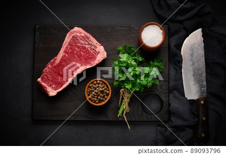 Fresh raw piece of beef meat, striploin steak on a black background, top view. Marbled piece of meat New York Fresh raw piece of beef meat, striploin steak on a black background, top view. Marbled piece of meat New York 89093796