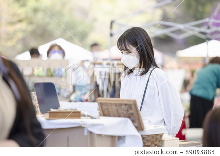 A young woman in a mask shopping at Marche A young woman in a mask shopping at Marche 89093883