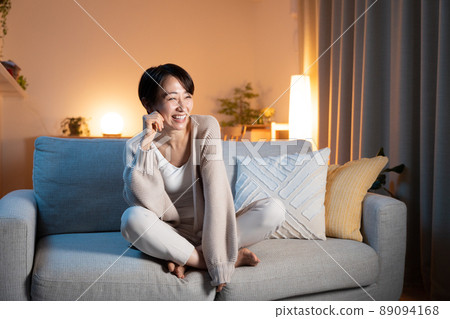 Woman relaxing at home at night 89094168