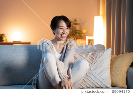 Woman relaxing at home at night 89094170