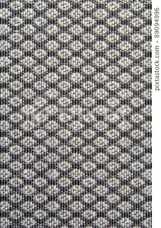 Knitted texture. Texture of jacquard fabric with gray geometric pattern. Crochet mosaic pattern Knitted texture. Texture of jacquard fabric with gray geometric pattern. Crochet mosaic pattern 89094996