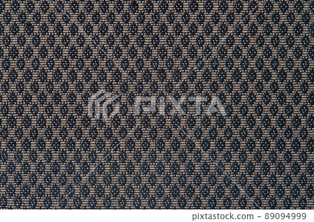 Knitted texture. Texture of jacquard fabric with gray geometric pattern. Crochet mosaic pattern 89094999
