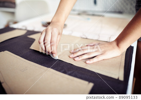 Seamstress Outlining Cardboard Pattern Seamstress Outlining Cardboard Pattern 89095133