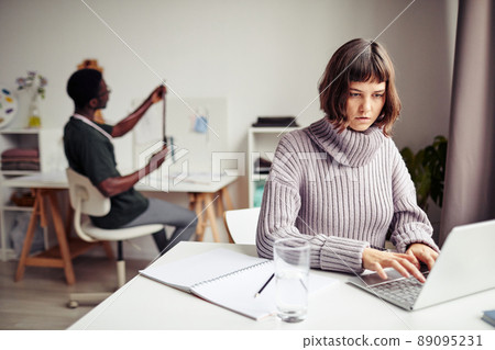 Concentrated Woman Working on Laptop Concentrated Woman Working on Laptop 89095231