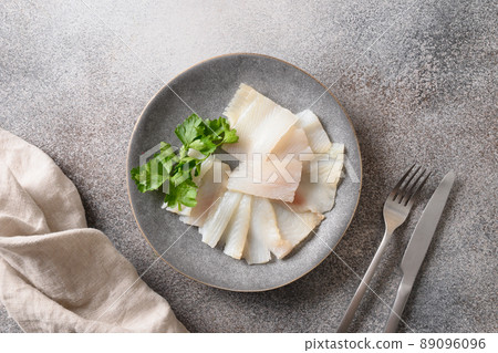 Delicious smoked halibut slices served in gray plate. 89096096