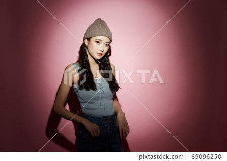 Cool portrait of a young woman in street fashion 89096250