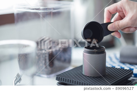 Barista women grinding coffee beans with manual grinder to making brew coffee at home. coffee drip equipment. lifestyle concept Barista women grinding coffee beans with manual grinder to making brew coffee at home. coffee drip equipment. lifestyle concept 89096527