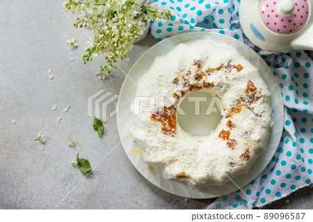 Pannacotta dessert. Cottage cheese souffle Panna cotta with apricots and coconut decor on a stone or slate on a light countertop. Top view flat lay background. Copy space. Pannacotta dessert. Cottage cheese souffle Panna cotta with apricots and coconut decor on a stone or slate on a light countertop. Top view flat lay background. Copy space. 89096587