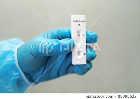 Asian doctor in PPE suit show positive test result with Saliva A 89096622