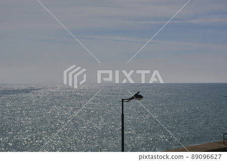 Lamppost on a bright day by the sea Lamppost on a bright day by the sea 89096627