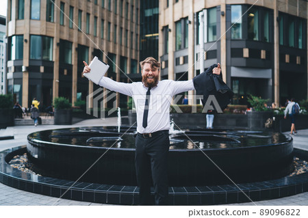 Cheerful man celebrating success on street 89096822