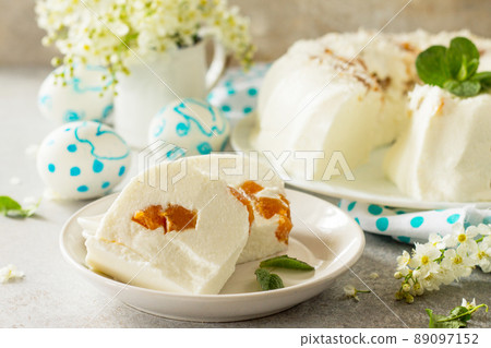 Pannacotta dessert. Cottage cheese souffle Panna cotta with apricots on a stone or slate on a light countertop. 89097152