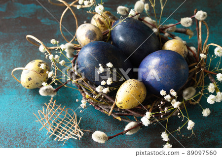 Classic blue 2020. Blue easter eggs in a nest close-up on a blue stone or slate background. Classic blue 2020. Blue easter eggs in a nest close-up on a blue stone or slate background. 89097560