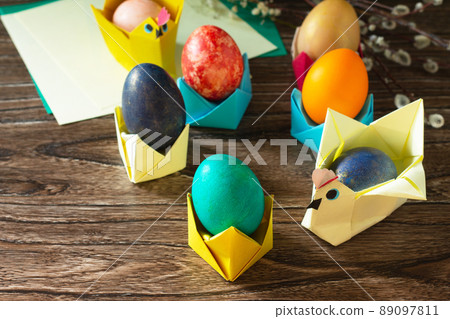 Children's gift Easter egg wrapping on a wooden table. Handmade. The project of children's creativity, crafts, crafts for children. 89097811