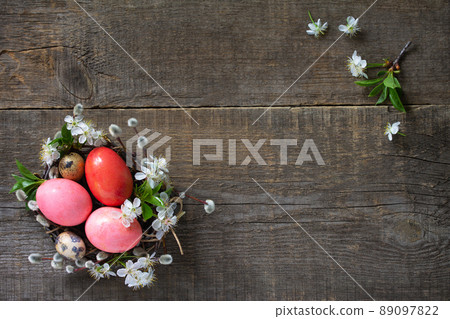 Easter background with  Pink handmade Easter eggs and spring flowers. Top view flat lay background. Copy space. 89097822