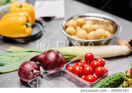 Close-up of fresh tomatoes, onion and celery on table for cooking vegetable salad 89098163