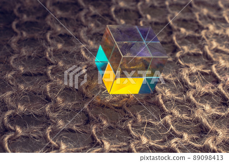 Colorful bright glass prism cube  Refracting light in vivid rainbow colors. 89098413