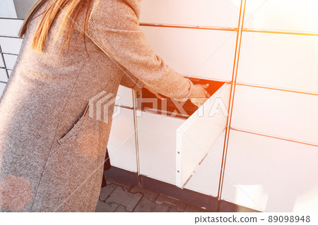 Postal terminal. Post delivery automat service and hands with parcel courier box. Mail delivery and post service concept. 89098948