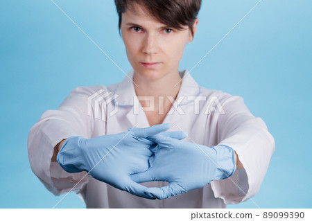 woman's doctor's hands in blue latex gloves together. concept preparation for the operation 89099390