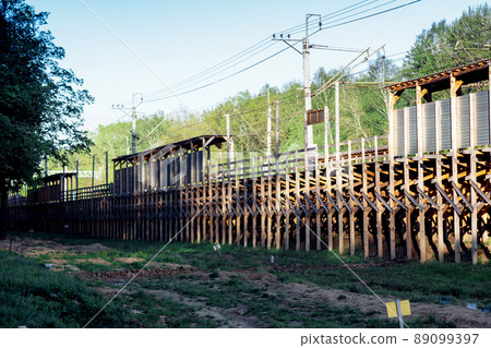 Temporary wooden railway station. The platform is made of wooden planks while the station is being repaired. Temporary wooden railway station. The platform is made of wooden planks while the station is being repaired. 89099397
